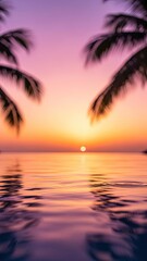 Tropical sunset silhouette on a paradise beach with palm trees and an orange evening sky over the ocean water