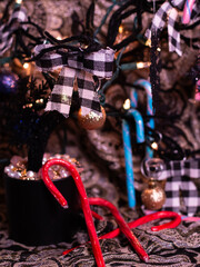 Candy canes, Christmas bows and pearls. The theme of the Christmas tree is black, gold and white with an accent of red.