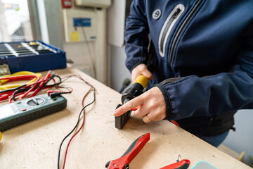 Person crimping electrical wire for professional connection