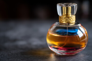 An elegantly designed perfume bottle showcases a beautiful interplay of colors in the liquid, reflecting luxury and sophistication in fragrance presentation and design.