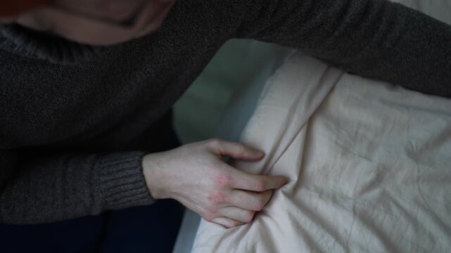 Man displaying several bleeding scratches and wounds on her hands following a cat attack, caused by a risky and intense play session with her pet, underscoring the potential for injury