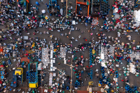 Aerial view of a bustling market scene teeming with activity, people, and goods in a vibrant display of commerce, Chattogram, Chittagong Division, Bangladesh.