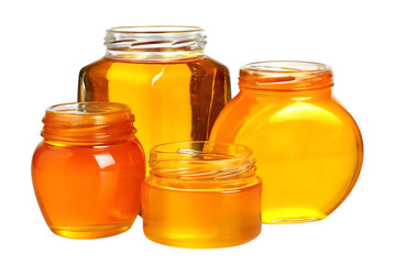 Four glass jars filled with golden honey isolated on white background