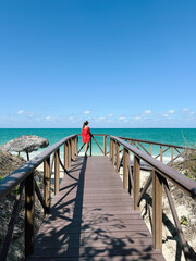 Woman on a Pier Overlooking the Ocean