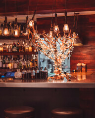 Rustic Bar Interior with Decorative Tree Wrapped in Warm String Lights