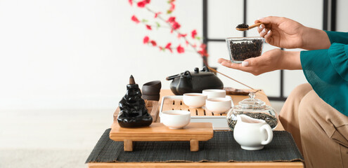 Woman brewing Asian black tea at home