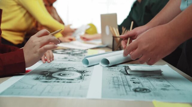 A diverse group collaborates around a table, sharing ideas and working on project plans during a creative brainstorming session, highlighting teamwork and innovation. SACTR