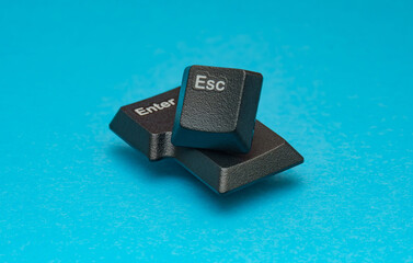 Reel dismantled technology parts. The ESC and ENTER keyboard keys, provide a physical metaphor for decision-making and digital interaction. Perfect for website design. Selective focus.