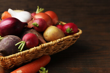 Different raw vegetables on wooden table, closeup. Space for text