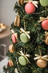 Sweet holiday concept: pastel-colored french macarons hung as edible ornaments on the branches of a decorated christmas tree