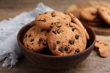 Delicious chocolate chip cookies in bowl on table, closeup