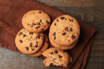 Yummy chocolate chip cookies on wooden table, top view