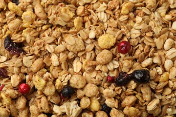 Tasty granola with dried fruits as background, top view