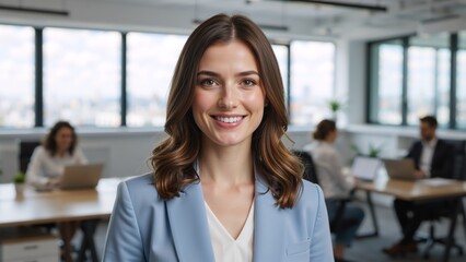 Confident smiling businesswoman looking at the camera. Professional young female employee headshot portrait in a modern office environment