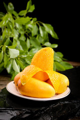 Fresh Cut Mango Slices on Plate with Green Leaves