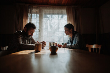 Portrait of poor mature couple sitting at table, fearing the future.