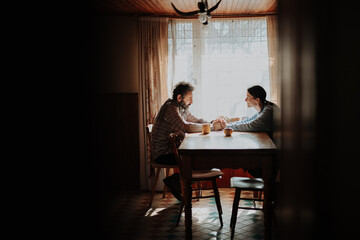 Fototapeta premium Portrait of poor mature couple sitting at table, fearing the future.