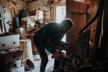 Man looking for firewood for heating at home.