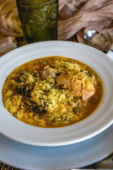 Homemade recipe for rice with chicken and broccoli on a dining table at home