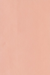 Vertical macro close-up showcasing the fine Saffiano crosshatch texture on a matte peach pink synthetic or faux leather surface