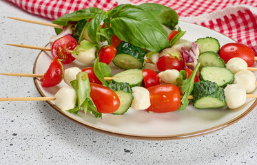 Appetizer of fresh vegetables and cheese on wooden skewers