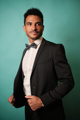 Confident man in a formal suit posing happily