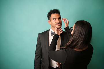 Makeup artist applying makeup to actor before event