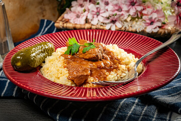 Chunky beef stew with savory sauce, served with bulgur groats.