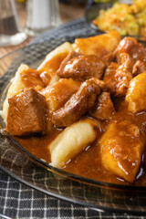Beef stew in gravy, served with potato dumplings.