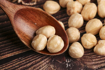 Roasted Macadamia Nuts Unshelled in Wooden Spoon
