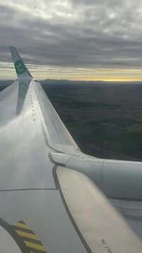 Vertical video. Airplane wing vibration in turbulent airflow during flight.