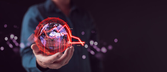 Businessman hand holding virtual world globe with red down arrow graph. Global economic recession concept. Financial crisis, stock market crash, and high inflation business risk background. © death_rip