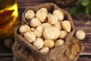 Premium Roasted Cashew Nuts in Burlap Sack on Rustic Wood