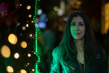 Informal Portrait of a Woman Looking at Christmas Lights in a European City on a Winter Night