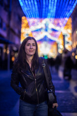 Informal Portrait of a Woman Looking at Christmas Lights in a European City on a Winter Night