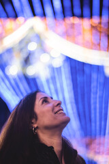 Informal Portrait of a Woman Looking at Christmas Lights in a European City on a Winter Nigh