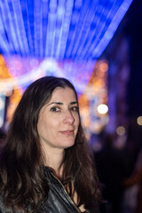 Informal Portrait of a Woman Looking at Christmas Lights in a European City on a Winter Night