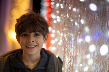 Portrait of a Ten-Year-Old Child Beside Christmas Lights at Night
