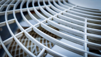 plastic basic fan cover with a geometric grid pattern and signs of use. heat wave, weather or abstract design element. background banner.