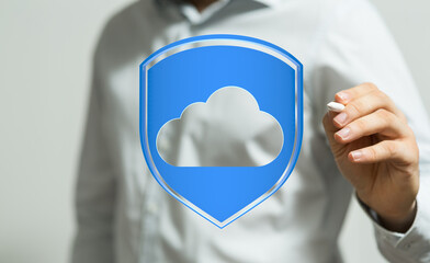 Secure cloud data protection concept, person touching a cloud inside a blue shield, representing privacy and on