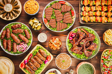 Arabic Cuisine; A variety of grilled meat dishes such as grilled fillet, ribs, kofta, tarb and shish tawook. Served with delicious side dishes. Top view with close up.