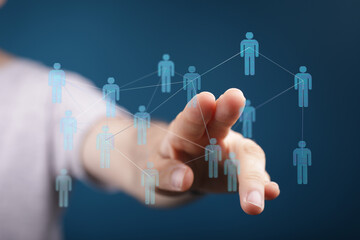Hand reaching out to touch a network of people. Represents concepts like communication, technology, and connection. Ideal for business and socia