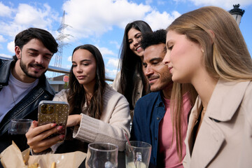 Diverse friends connecting social media smartphone at cafe