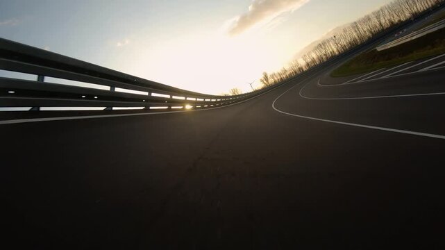 driving a Race Car on a racetrack on a sunny day. POV view