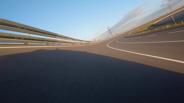 driving a Race Car on a racetrack on a sunny day. POV view