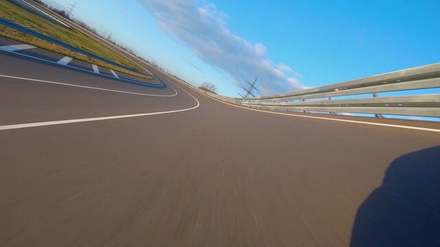 driving a Race Car on a racetrack on a sunny day. POV view
