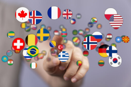 A hand pointing at various country flags representing international connections, global teamwork, and multicultural understanding. Ideal for con