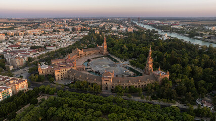 Fototapeta premium Sunset aerial view of historic architecture and the Guadalquivir River of the Sur district of Seville, Andalusia, Spain.