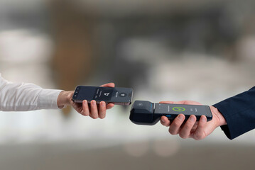 Smartphone making contactless payment to mobile POS terminal, showing successful digital transaction and modern wireless payment technology