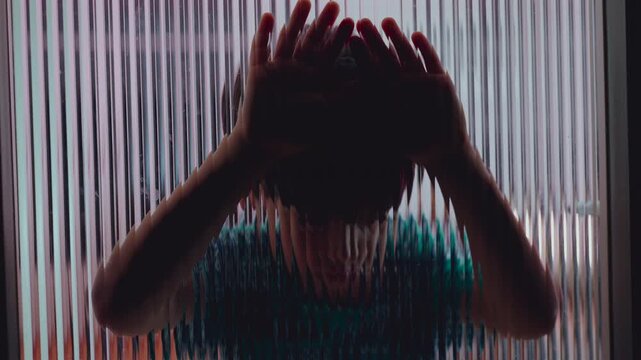 Child silhouette pressing hands against textured glass door,  childhood isolation emotional distance trauma depression and unseen internal struggles